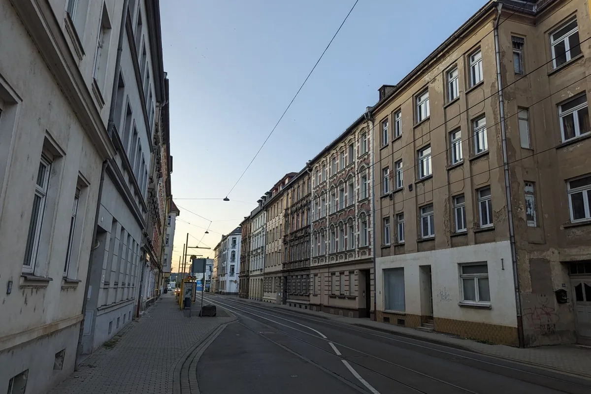 Mehrfamilienhäuser säumen eine ruhige innerstädtische Straße